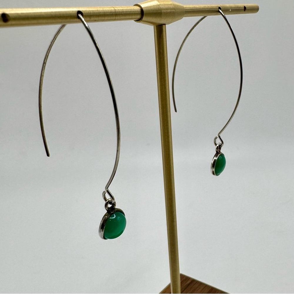 Long silver thread dangle earrings with green glass.